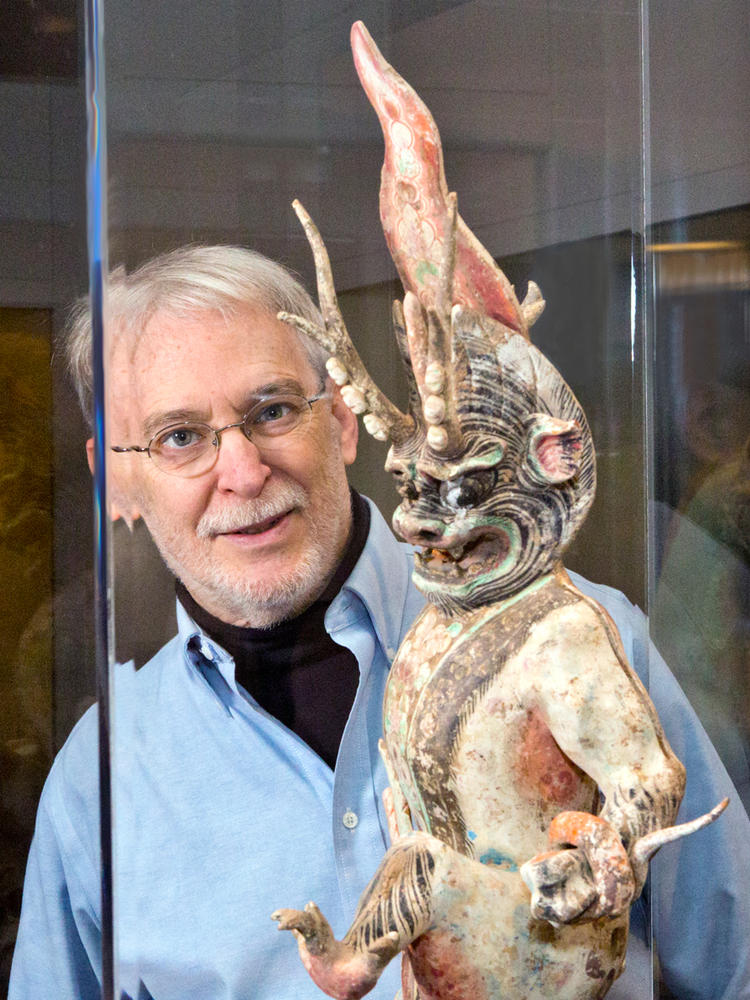 Man admiring sculpture in a museum exhibit